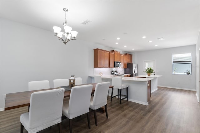 dining area with visible vents, dark wood finished floors, baseboards, a notable chandelier, and recessed lighting