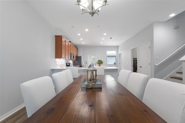 dining area featuring visible vents, wood finished floors, stairway, an inviting chandelier, and recessed lighting