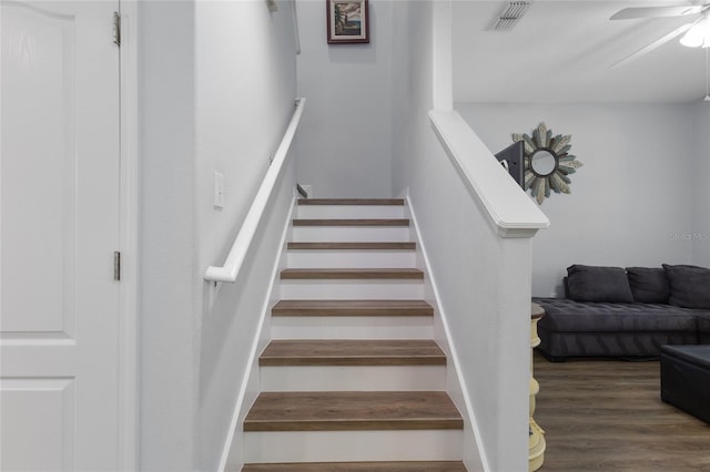 stairs with visible vents, a ceiling fan, and wood finished floors