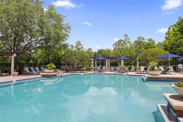 pool featuring a patio and fence