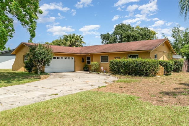 ranch-style house with a garage, a front lawn, stucco siding, and concrete driveway