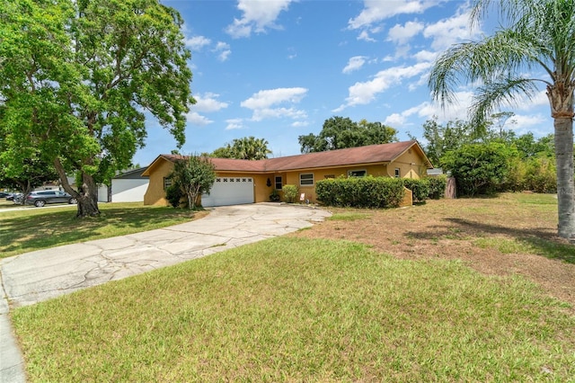 single story home featuring an attached garage, a front lawn, driveway, and stucco siding