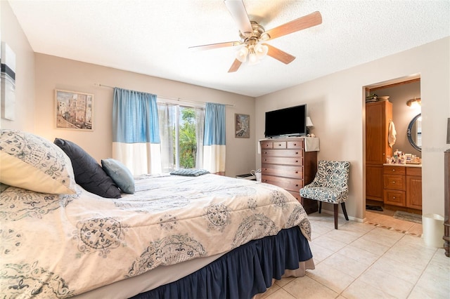 bedroom featuring a ceiling fan, light tile patterned floors, and ensuite bathroom