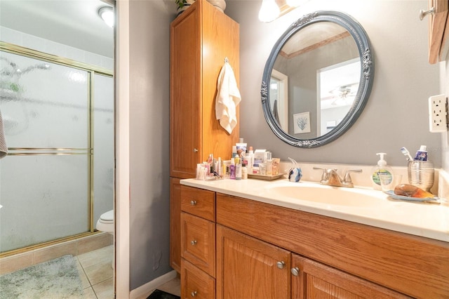 full bath with toilet, a shower stall, tile patterned flooring, and vanity