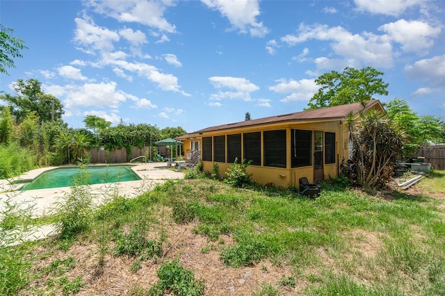 back of house featuring a fenced in pool, fence, and a patio