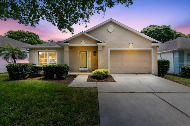 3661 Kingswood Ct, Clermont, FL 34711 - ranch-style home with a lawn, an attached garage, stucco siding, and concrete driveway