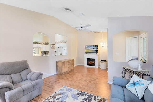 3661 Kingswood Ct, Clermont, FL 34711 - living room with visible vents, arched walkways, light wood-style floors, and lofted ceiling