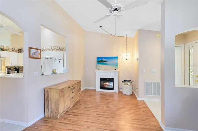 3661 Kingswood Ct, Clermont, FL 34711 - living area featuring a ceiling fan, baseboards, visible vents, and light wood-style flooring