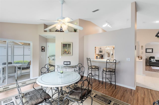3661 Kingswood Ct, Clermont, FL 34711 - dining space featuring visible vents, wood finished floors, baseboards, a ceiling fan, and vaulted ceiling