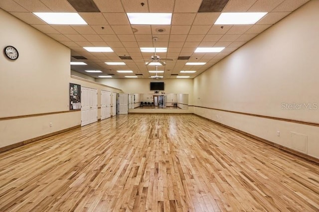3661 Kingswood Ct, Clermont, FL 34711 - workout room featuring a paneled ceiling, baseboards, and wood finished floors