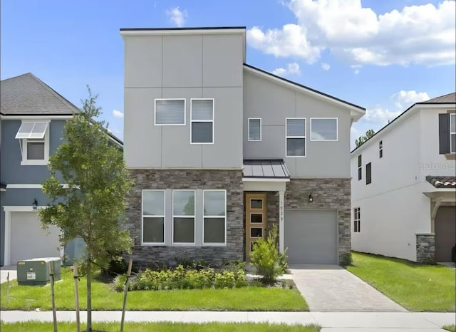 1929 Tropical Palms Cir, Kissimmee, FL 34747 - contemporary home with a garage, stone siding, stucco siding, a standing seam roof, and driveway