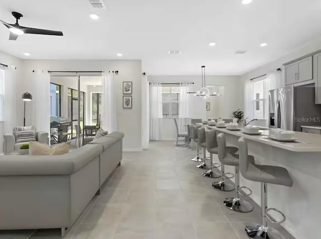 1929 Tropical Palms Cir, Kissimmee, FL 34747 - living area with ceiling fan with notable chandelier, recessed lighting, and visible vents