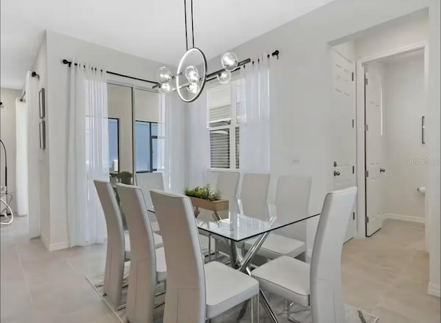 1929 Tropical Palms Cir, Kissimmee, FL 34747 - dining space with baseboards and an inviting chandelier