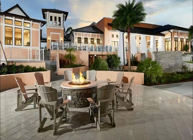 1929 Tropical Palms Cir, Kissimmee, FL 34747 - patio terrace at dusk with a fire pit