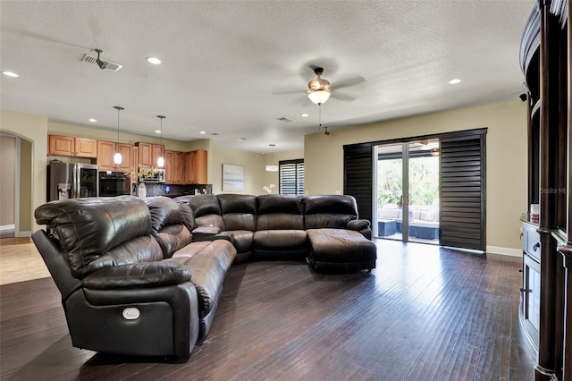 living area with a ceiling fan, visible vents, and recessed lighting