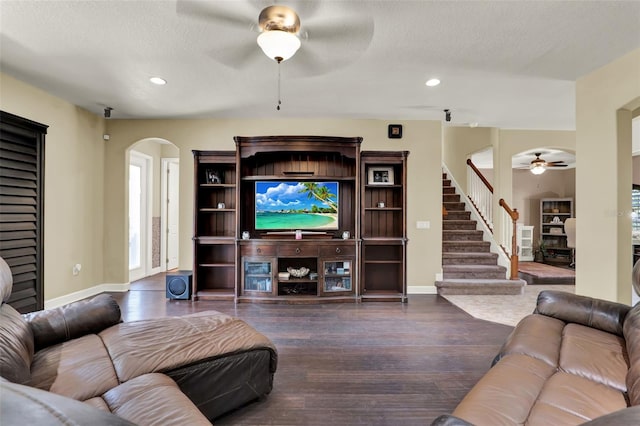 living room featuring arched walkways, a ceiling fan, baseboards, recessed lighting, and wood finished floors