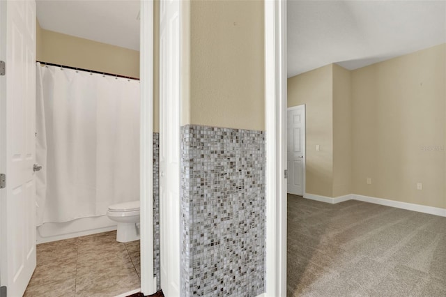 bathroom with shower / bathtub combination with curtain and toilet