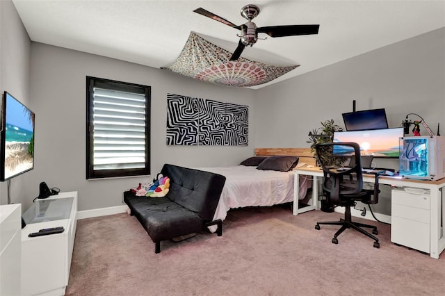 carpeted bedroom featuring baseboards and a ceiling fan