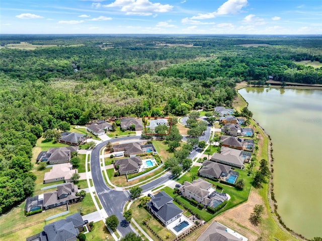 aerial view with a water view, a view of trees, and a residential view