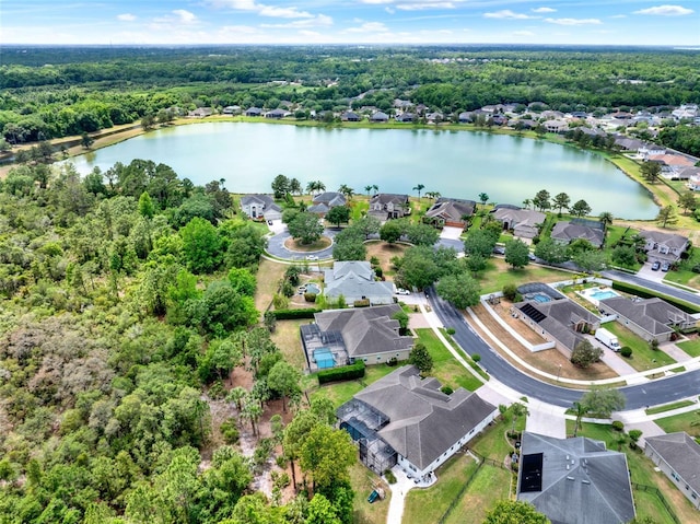 birds eye view of property with a water view, a residential view, and a forest view