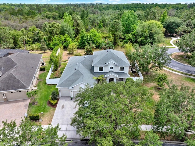 drone / aerial view featuring a wooded view