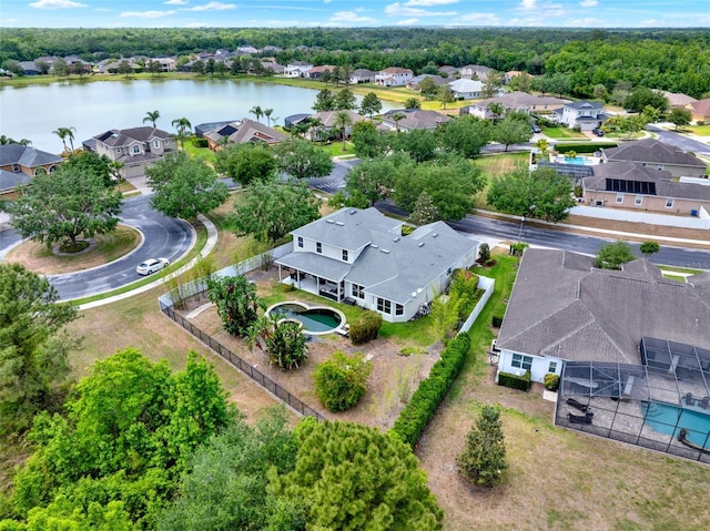 drone / aerial view with a water view and a residential view