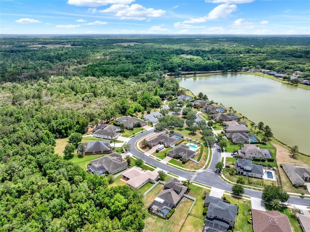 bird's eye view featuring a residential view, a water view, and a wooded view