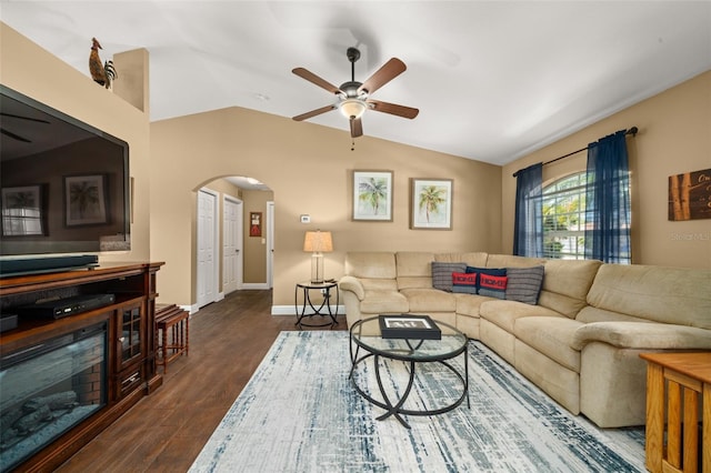 living room featuring arched walkways, a ceiling fan, baseboards, lofted ceiling, and dark wood-style floors