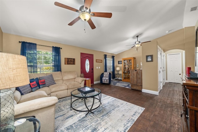 living room featuring ceiling fan, visible vents, wood-type flooring, baseboards, and vaulted ceiling