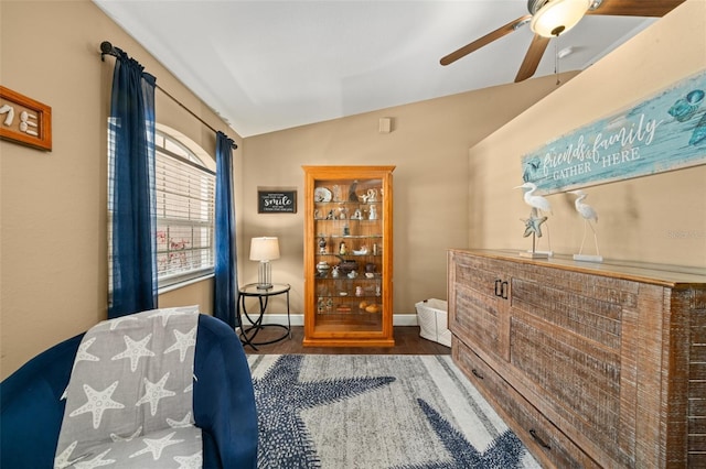 sitting room featuring baseboards, a ceiling fan, vaulted ceiling, and wood finished floors