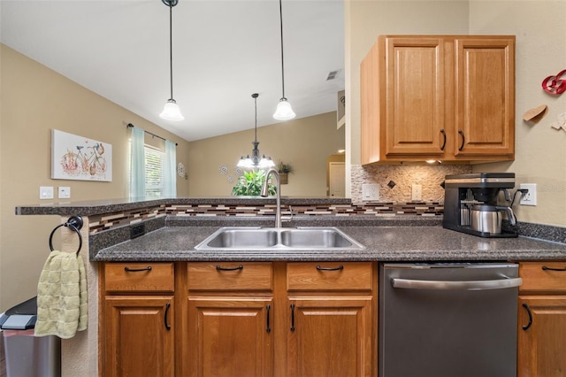 kitchen featuring visible vents, dark countertops, stainless steel dishwasher, vaulted ceiling, and a sink