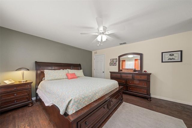 bedroom with baseboards, a ceiling fan, dark wood finished floors, and visible vents