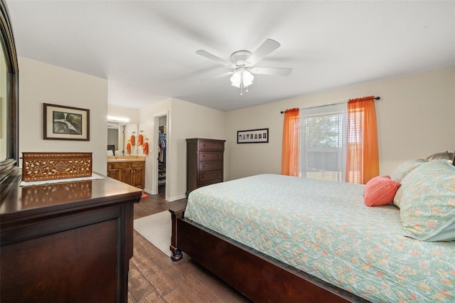 bedroom featuring a closet, baseboards, ceiling fan, dark wood-type flooring, and a spacious closet