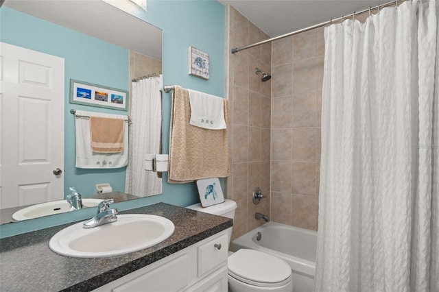 bathroom featuring vanity, shower / bath combination with curtain, and toilet