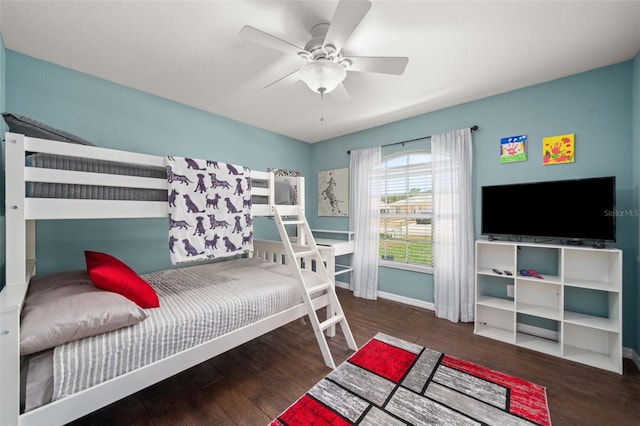 bedroom featuring a ceiling fan, baseboards, and wood finished floors