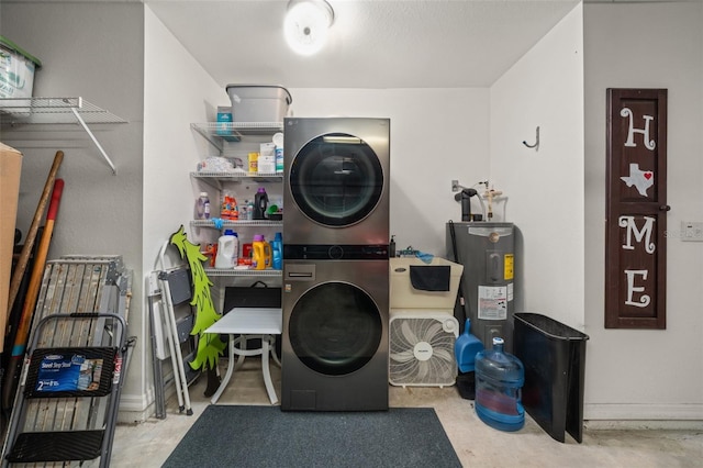 laundry room with laundry area, stacked washer and dryer, and water heater
