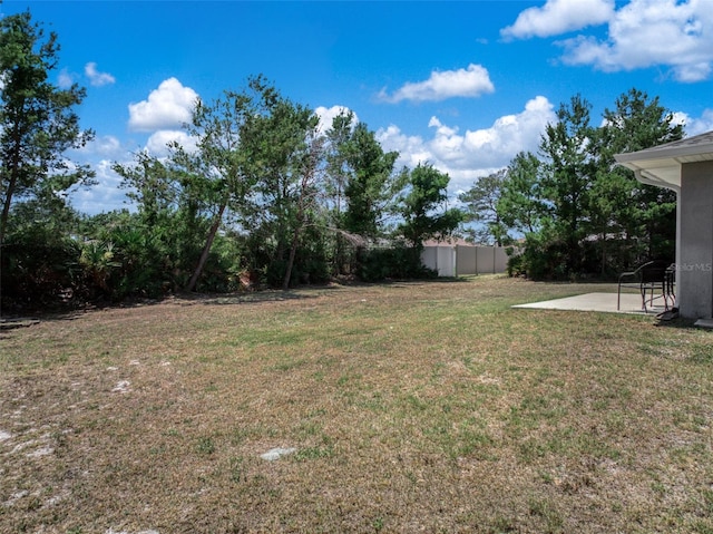 view of yard featuring fence and a patio area