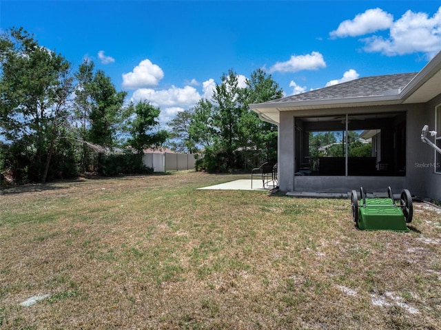 view of yard with a sunroom, a patio area, and fence