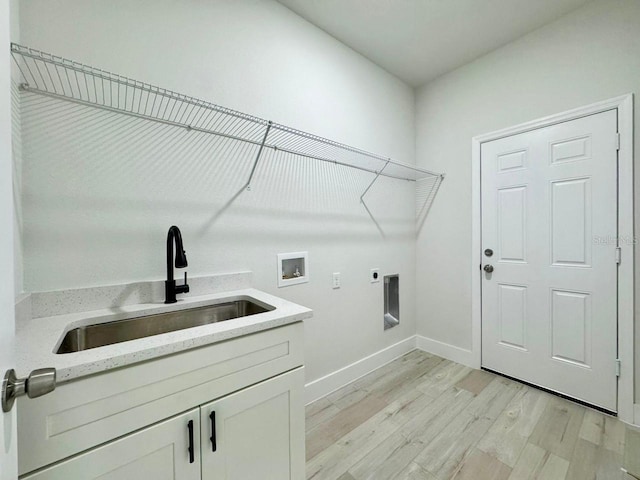 8120 N Maltese Dr, Citrus Springs, FL 34433 - laundry area featuring light wood-type flooring, hookup for an electric dryer, baseboards, washer hookup, and cabinet space