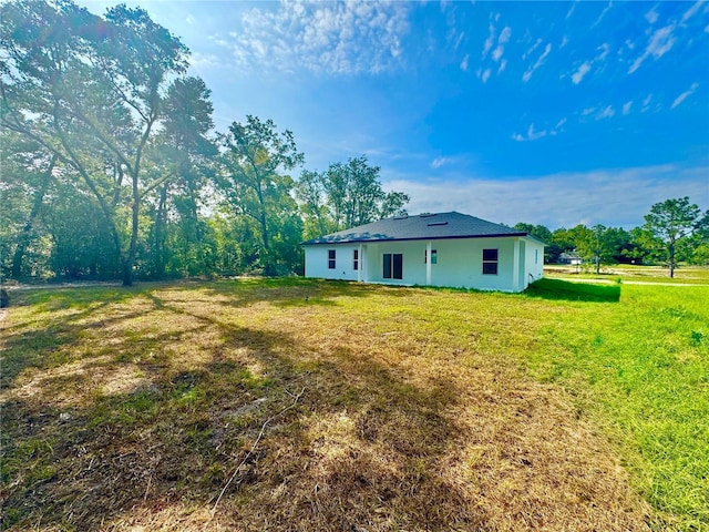 8120 N Maltese Dr, Citrus Springs, FL 34433 - rear view of property featuring a lawn