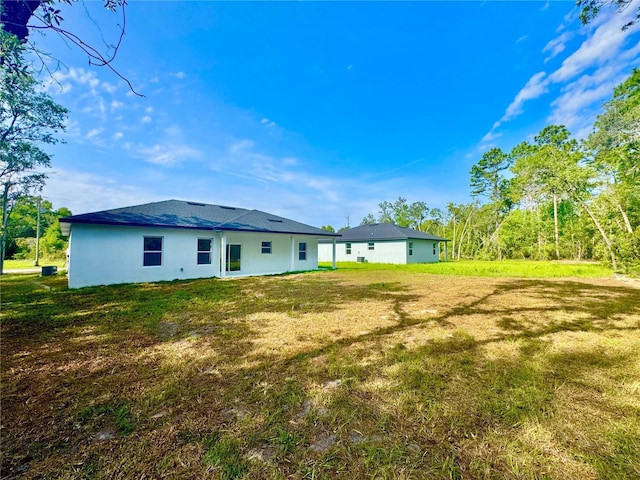 8120 N Maltese Dr, Citrus Springs, FL 34433 - back of house with a yard and stucco siding