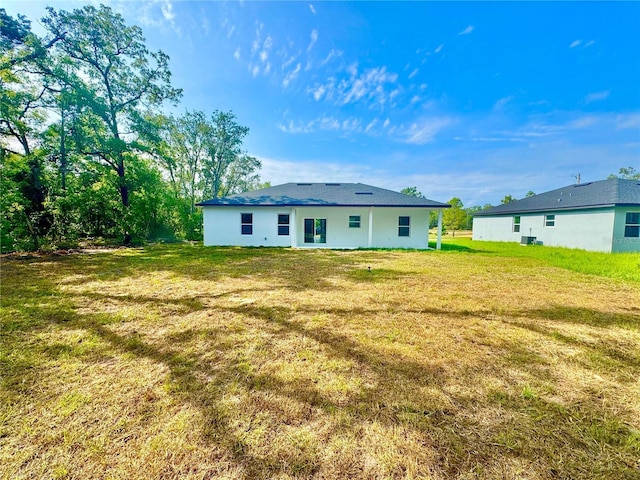 8120 N Maltese Dr, Citrus Springs, FL 34433 - rear view of house with a lawn