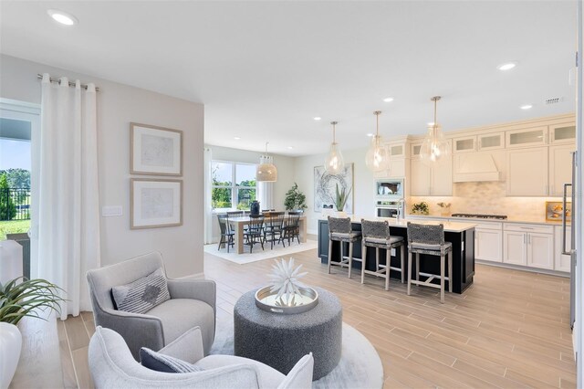 living area featuring recessed lighting and light wood-type flooring
