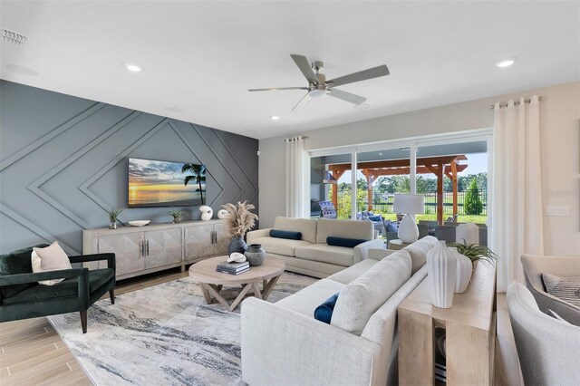 living room with visible vents, a ceiling fan, light wood-style flooring, and recessed lighting