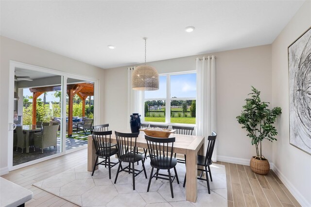 dining room featuring baseboards, recessed lighting, and light wood-style flooring
