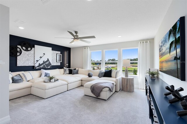 living area featuring carpet, a ceiling fan, and recessed lighting