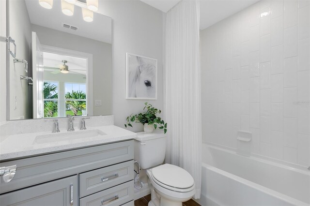 bathroom featuring visible vents, shower / bath combo with shower curtain, vanity, toilet, and ceiling fan