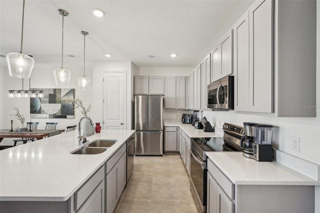 734 Longboat Dr, Davenport, FL 33896 - kitchen featuring stainless steel appliances, a sink, gray cabinets, recessed lighting, and hanging light fixtures