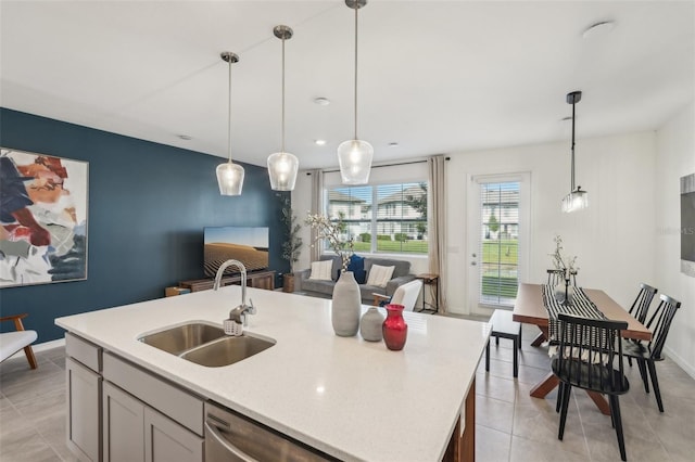 734 Longboat Dr, Davenport, FL 33896 - kitchen with a sink, light countertops, stainless steel dishwasher, pendant lighting, and a kitchen island with sink