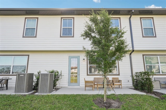 734 Longboat Dr, Davenport, FL 33896 - back of house with central air condition unit and a patio area